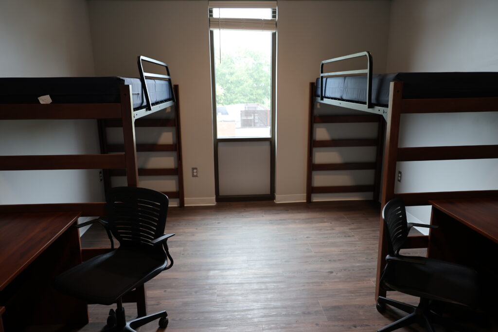 Empty room in manning showing two beds and a window