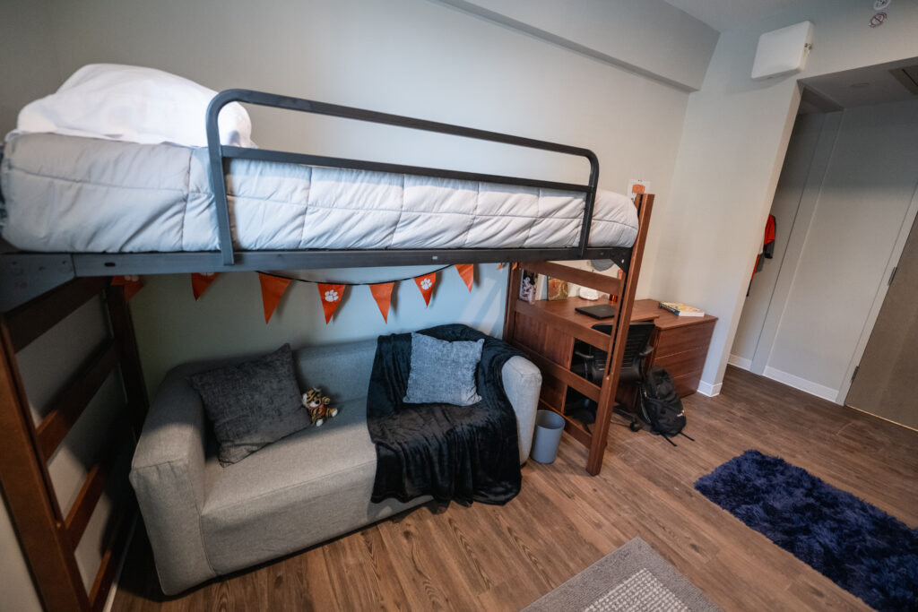View of lofted bed with couch underneath.