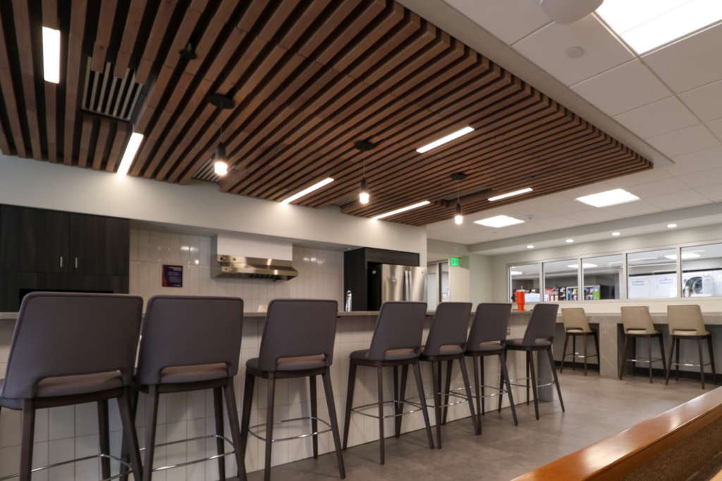 View of the downstairs kitchen with barstools.