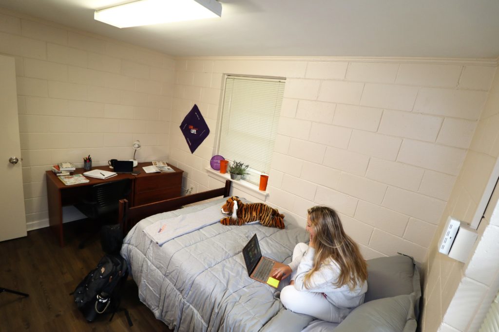 Student on computer sitting on bed in Thornhill