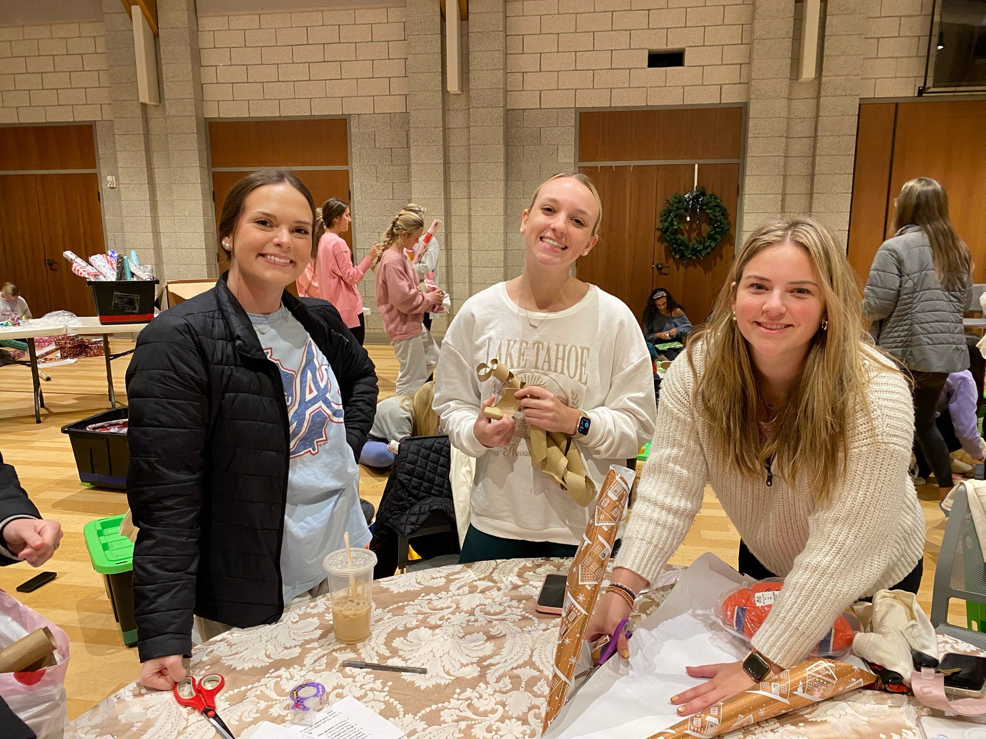 Teaching Fellows residents wrapping gifts at a volunteer event